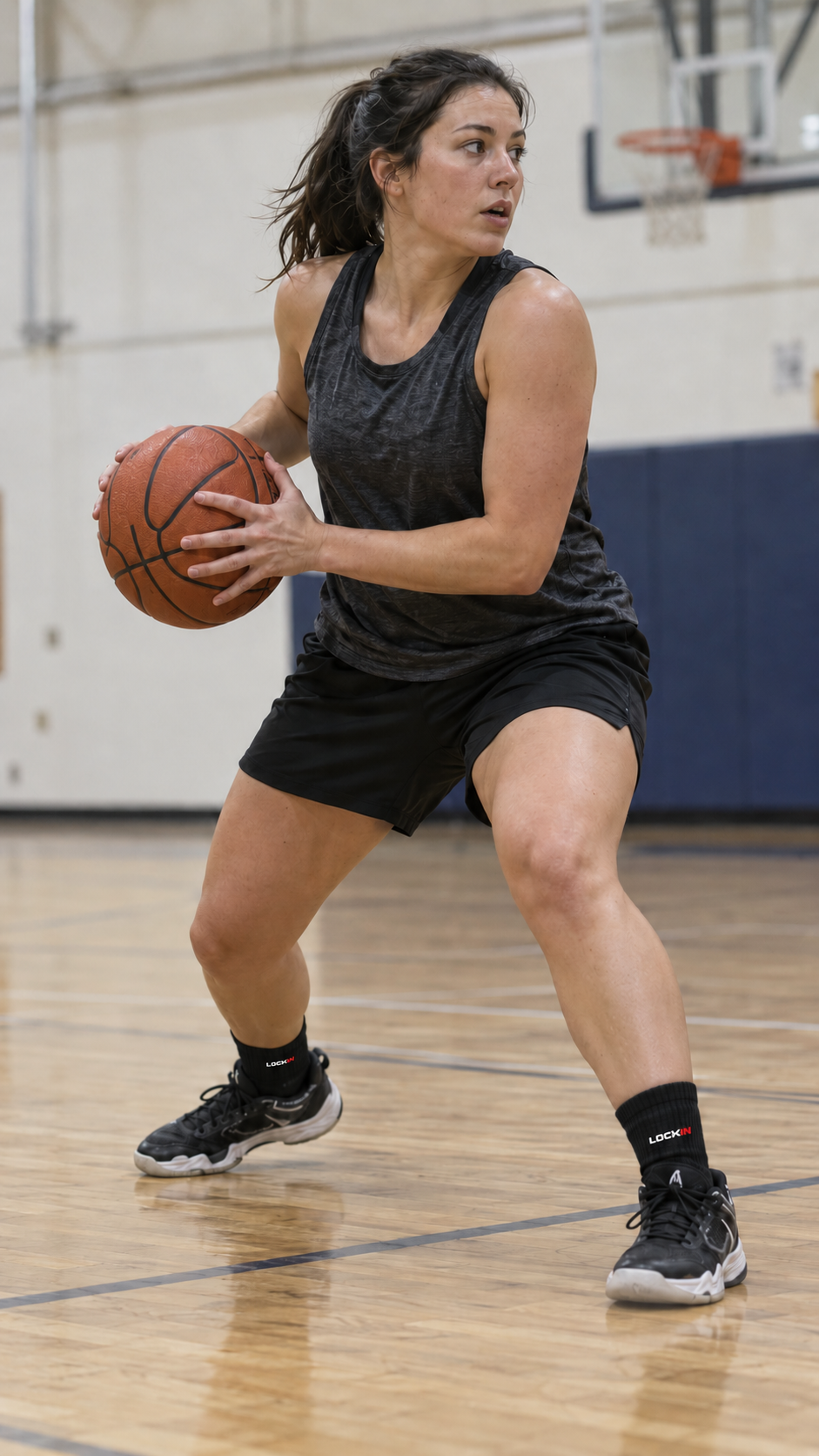 Illustrative adult woman basketball player making a low pivot in black crew socks and court shoes